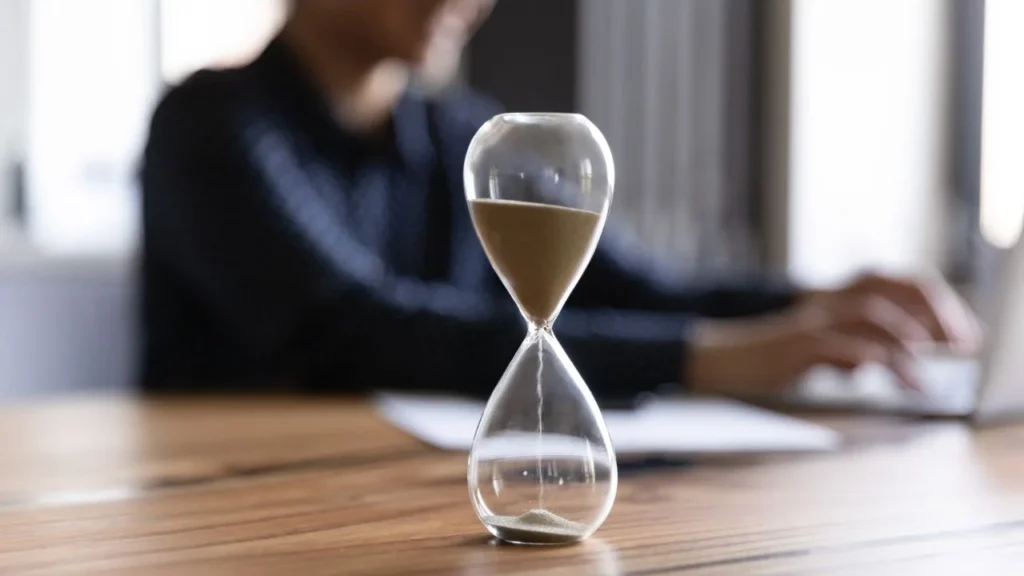 An hourglass counts down the working time